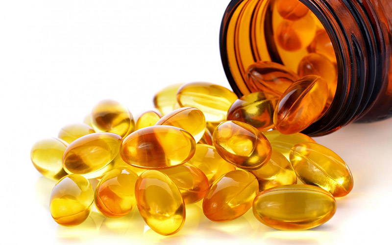 Fish-oil-bottle-emptied-on-table-with-gel-tabs Fish-oil-bottle-emptied-on-table-with-gel-tabs