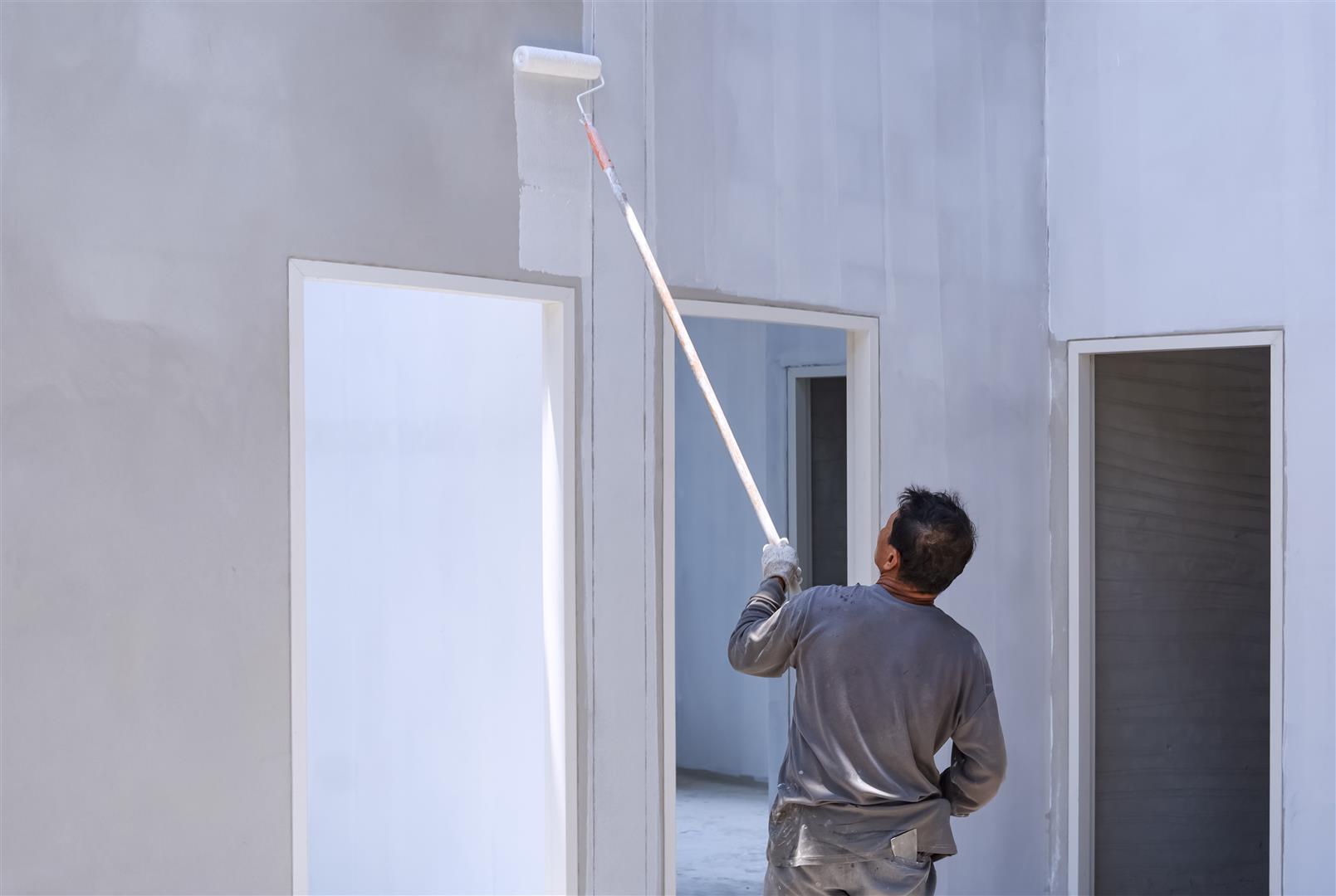 asian-builder-painting-primer-white-color-concrete-wall-inside-house-construction-site (Large) asian-builder-painting-primer-white-color-concrete-wall-inside-house-construction-site (Large)