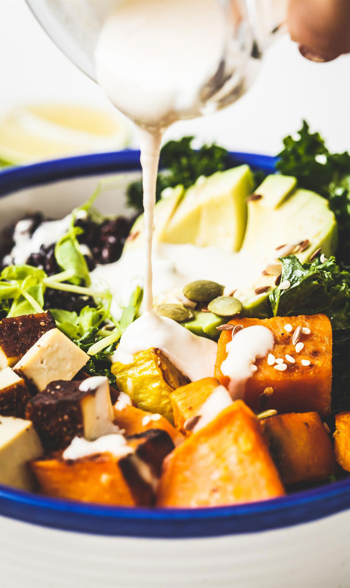cooking-vegan-salad-with-black-rice-avocado-tofu-sweet-potato-kale-tahini-dressing-(Custom)