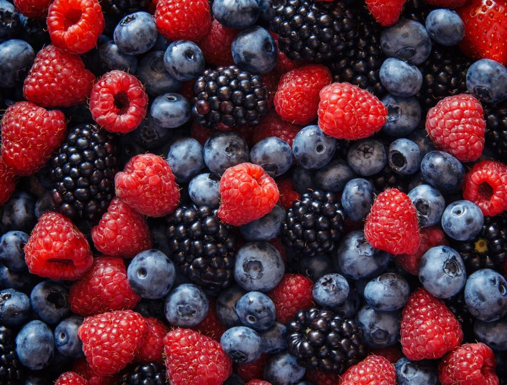 healthy-mixed-fruit-ingredients-from-top-view (Large) Sunscreen held in hand at beach