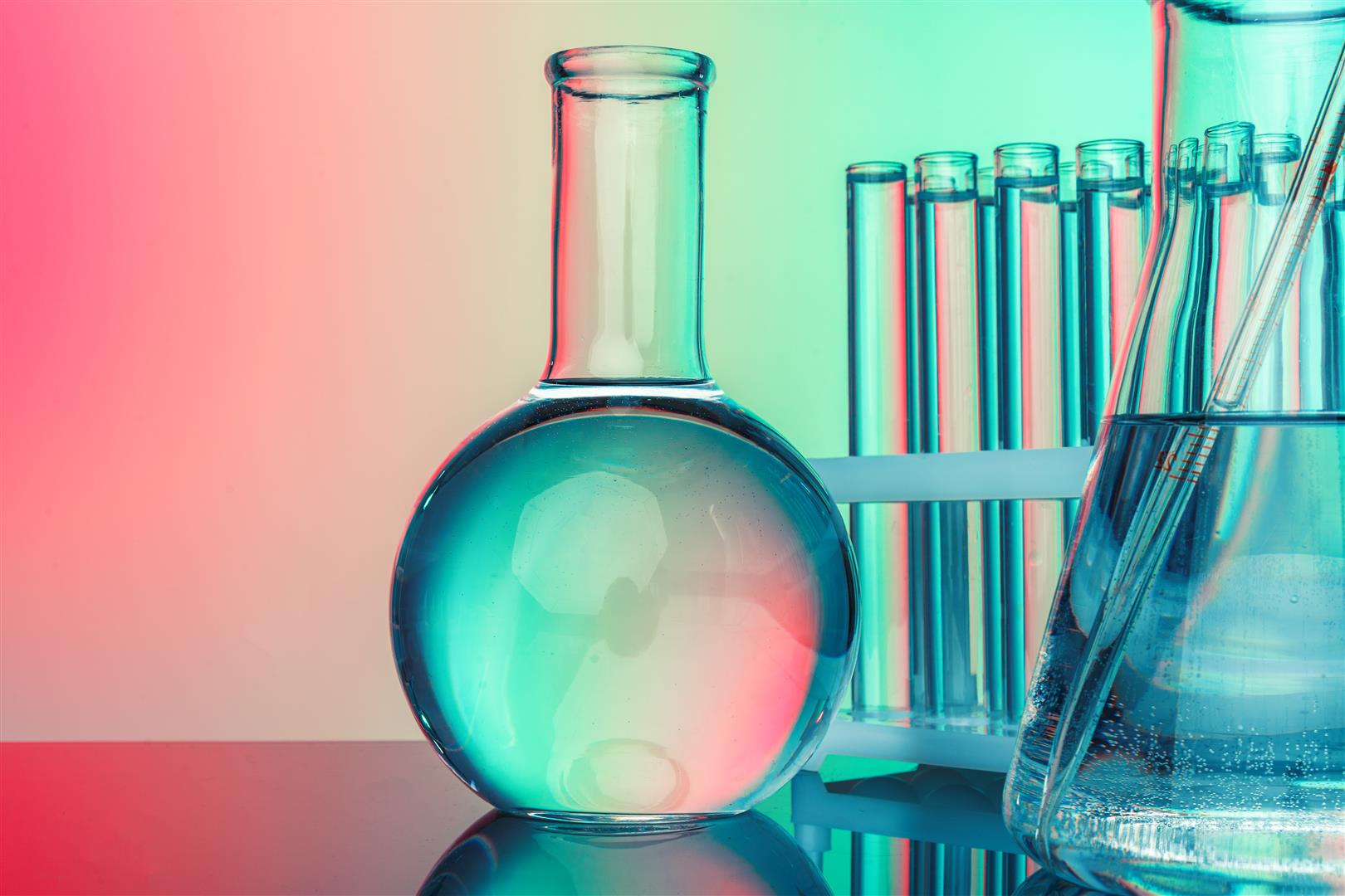 Laboratory chemistry glassware  on green toned background Research and development concept. Double exposure image of microbiology and chemistry in laboratory for medicine study.