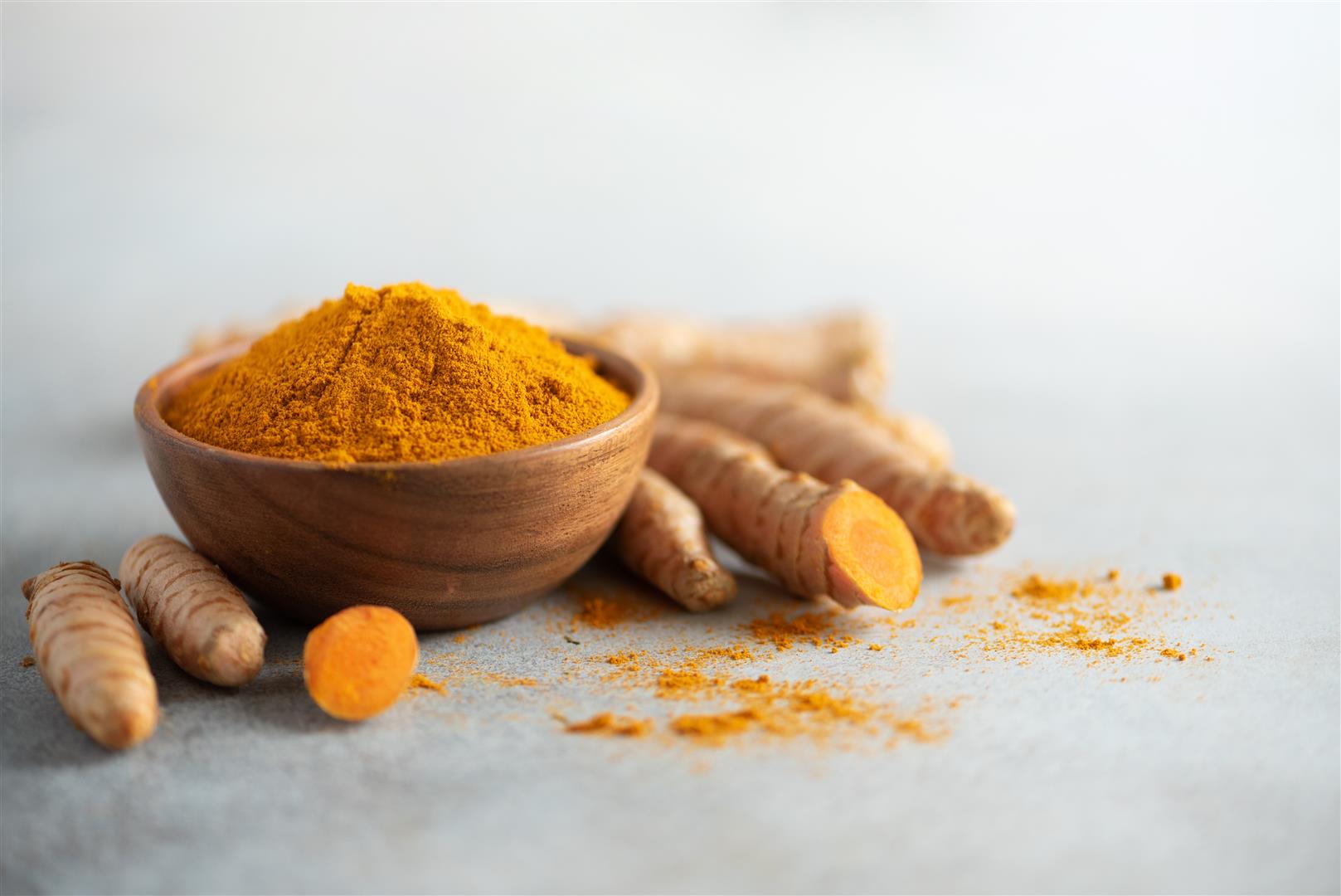 turmeric-powder-wooden-bowl-fresh-turmeric-root-grey-concrete-background (Large)