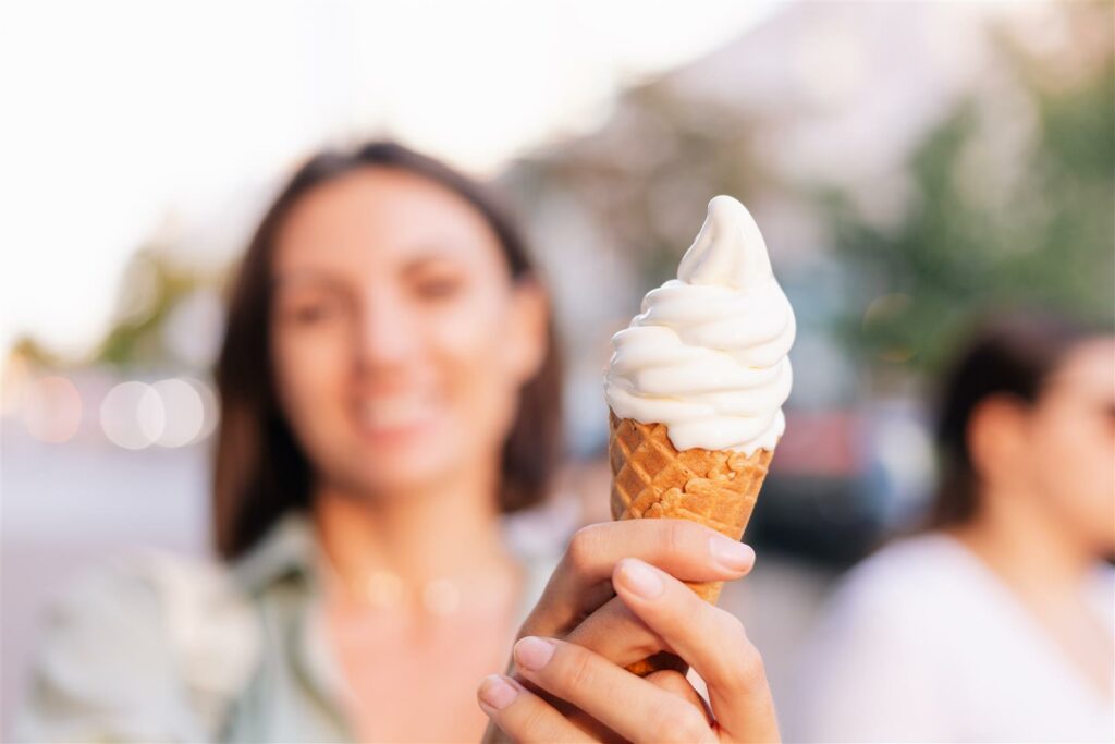 Caramel-Butterscotch-melted-liquid-1024x683 Woman outdoor  at summer sunset time having ice cream cone positive happy playful at city street